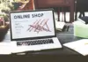 Online shopping experience with e-commerce concept for shopaholics, showcasing digital shopping on a laptop with shopping carts and products.