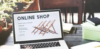 Online shopping experience with e-commerce concept for shopaholics, showcasing digital shopping on a laptop with shopping carts and products.