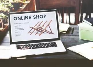 Online shopping experience with e-commerce concept for shopaholics, showcasing digital shopping on a laptop with shopping carts and products.